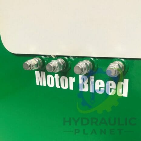 37 kW POWER UNIT-5 hydraulicplanet Four metal control valves labelled "Motor Bleed" are mounted on a green panel with "HYDRAULIC PLANET" partly visible below, resembling P40 SERIES MONOBLOCK CONTROL VALVES.
