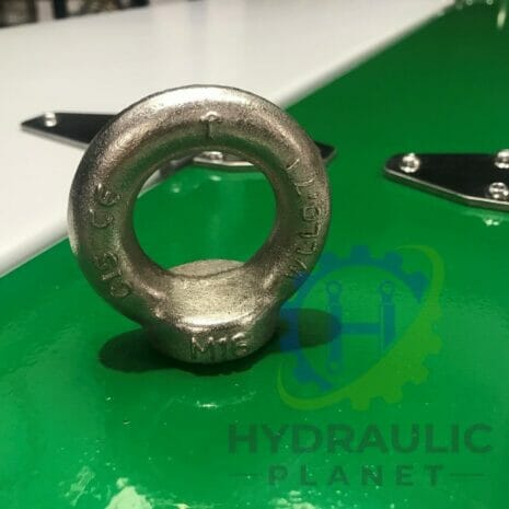 37 kW POWER UNIT-3 hydraulicplanet A metal lifting eye bolt marked "M16" and "C15 CE" stands upright on a green surface near the partial "HYDRAULIC PLANET" logo, likely part of the 37 kW POWER UNIT.